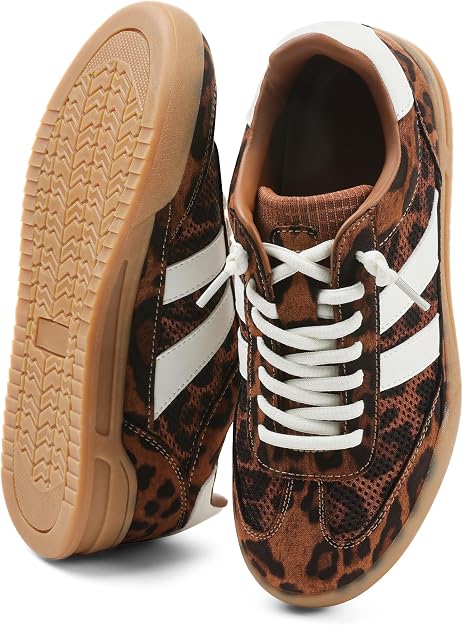 A pair of sneakers with brown leopard print, white side stripes, white laces, and light brown rubber soles. One shoe is upright, the other is on its side showing the tread.