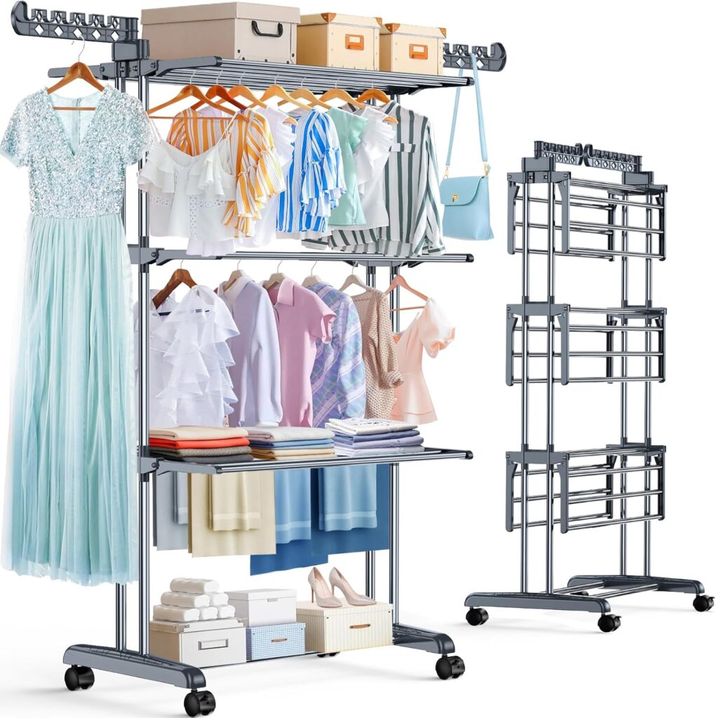 Two metal rolling garment racks; one holds dresses, shirts, boxes, folded clothes, bags, and shoes, while the other is empty and folded flat for storage. Both have multiple shelves and hanging rods.