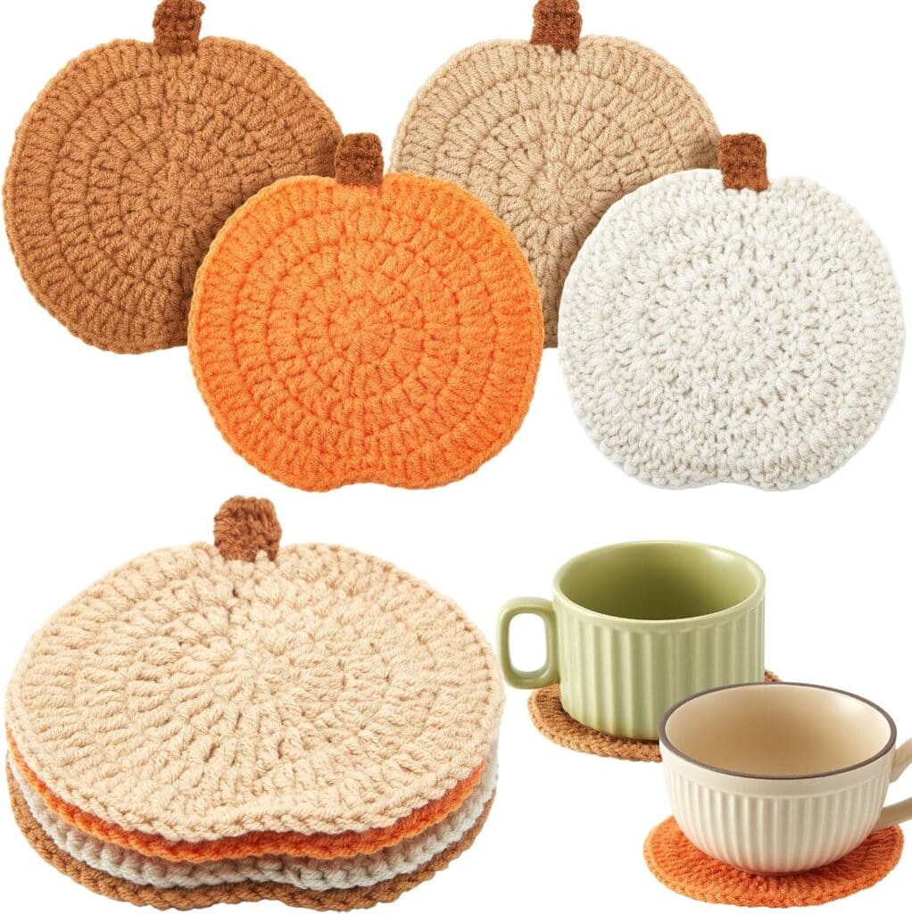 Five crochet pumpkin-shaped coasters in beige, orange, and brown tones are shown, with two cups placed on them in the lower right corner—perfect for sprucing up your autumn table settings and taking advantage of Monday Deals.