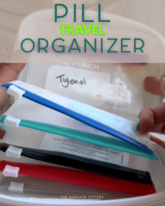 A hand holds a clear container labeled “Tylenol,” with several zippered pouches in red, blue, green, and black, organized inside. Large text reads “Pill Travel Organizer.”.