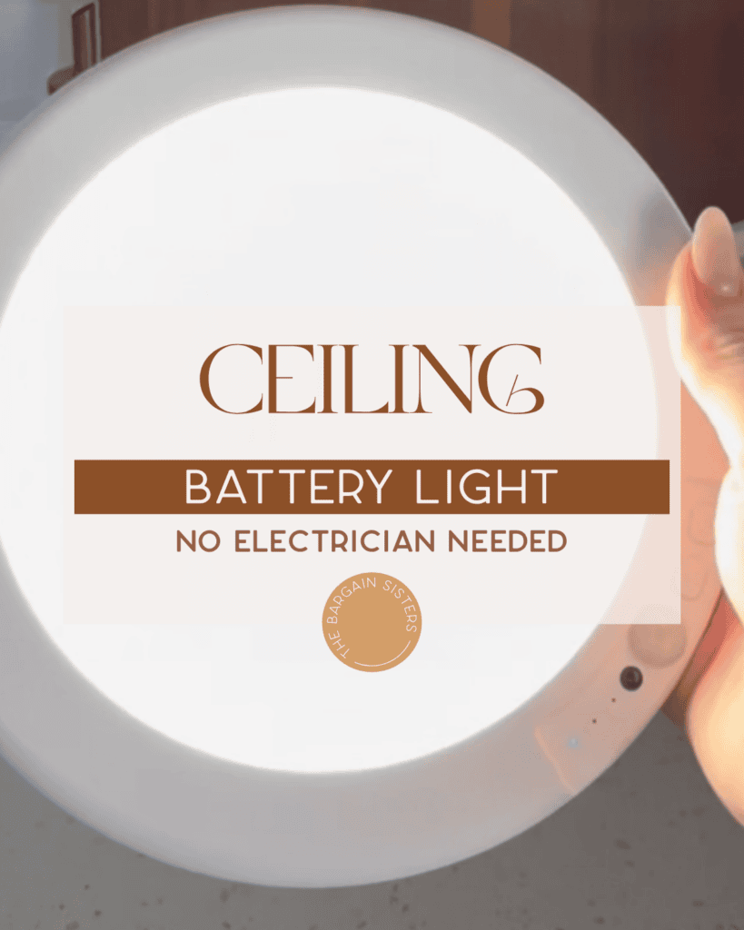 A hand holds a round, white ceiling battery light with text overlay reading “Ceiling Battery Light. No electrician needed.” The light glows brightly, and a gold logo appears at the bottom.