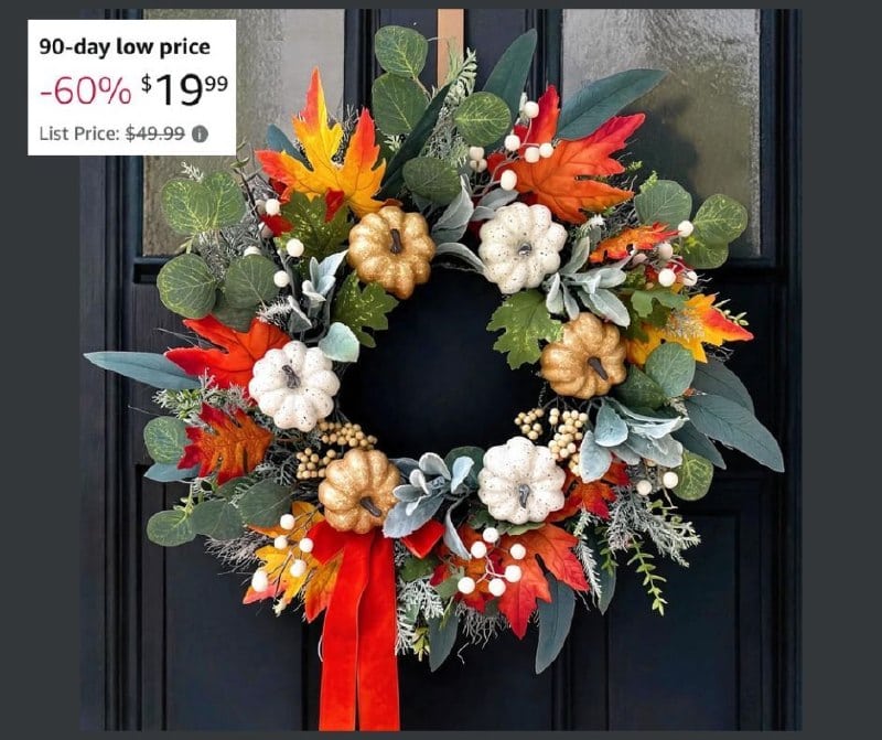 A fall wreath with orange and cream flowers, berries, and greenery—perfect for dressing up your front door this autumn, part of our Thursday Deals.