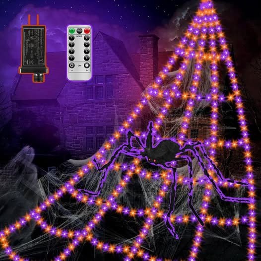 Giant light-up Halloween spider web decoration glowing across a front porch, featured in our Monday Deals.