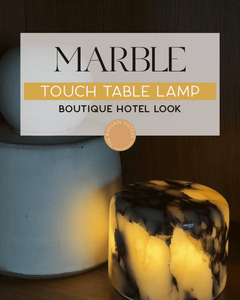 Two marble lamps are displayed on a wooden surface. One lamp is white and cylindrical, while the other is shorter, round, and glows with warm light, showcasing black and gold marble patterns. Text overlay promotes marble touch table lamps.