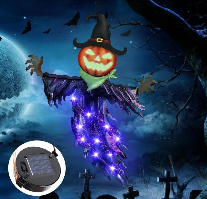 Solar powered Halloween decorations lighting up a front yard at night, featured in our Tuesday Deals.