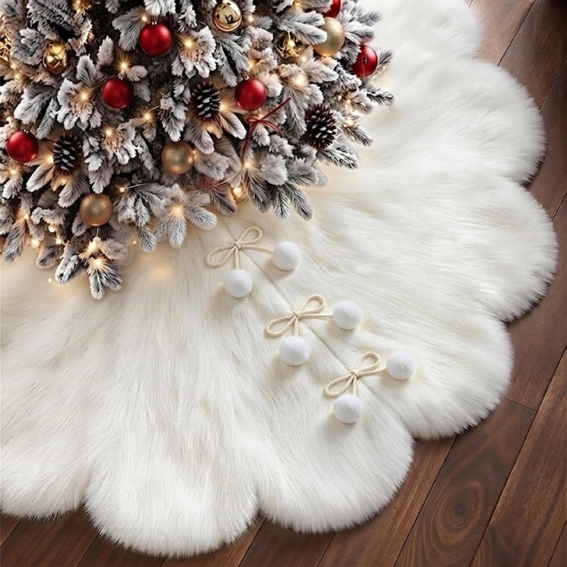 A plush 48 inch white faux fur Christmas tree skirt wrapped around the base of a decorated tree, featured in our Tuesday Deals.