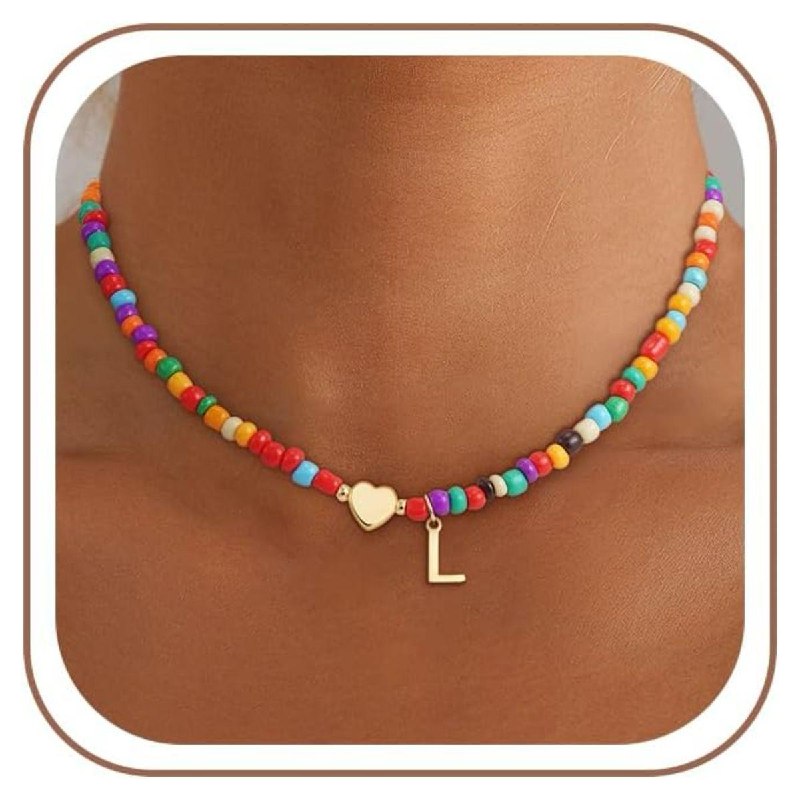 A dainty beaded initial necklace with a gold letter charm, featured in our Friday Deals.