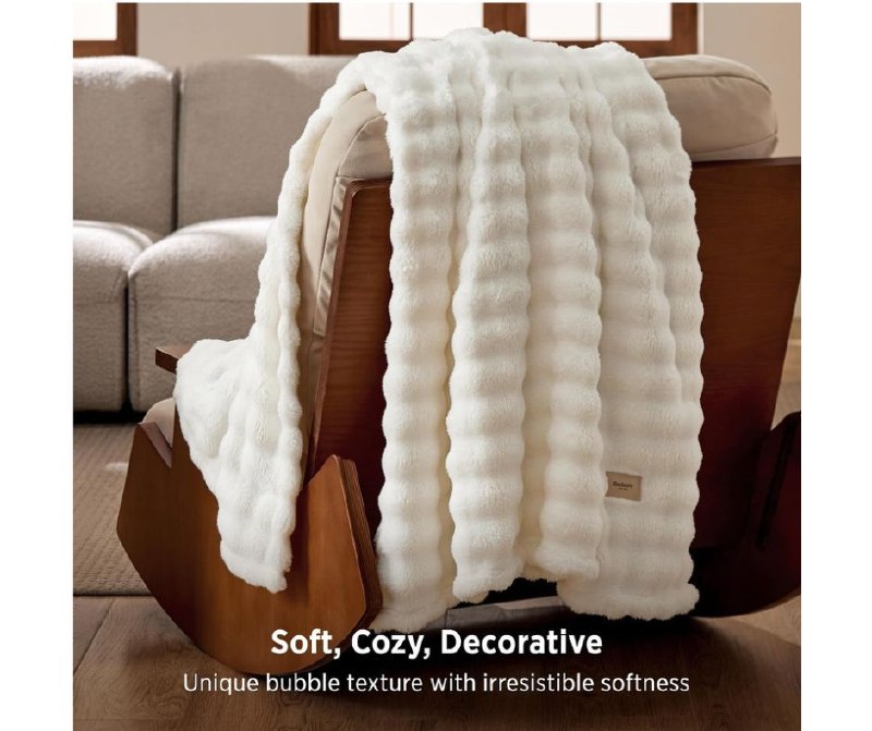 Soft, puffy cloud bubble throw blanket draped over a couch featured in our Tuesday Deals.