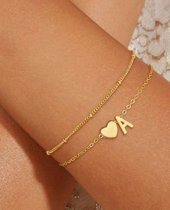 A dainty gold initial bracelet with a personalized letter charm on a delicate chain, featured in our Tuesday Deals.