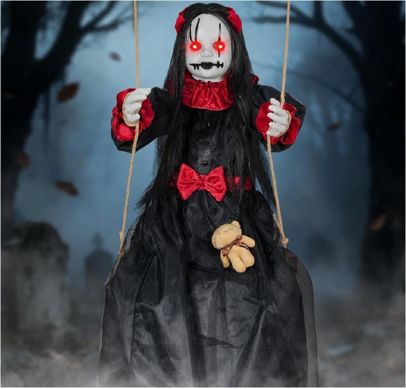 Creepy Halloween doll sitting on a hanging swing as porch decoration featured in our Tuesday Deals.