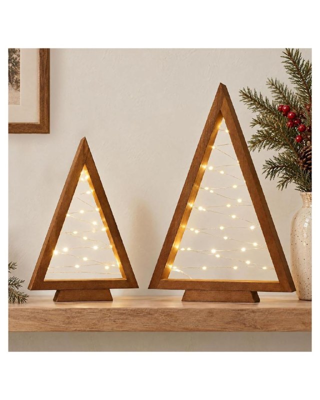 A set of two small decorative tabletop Christmas trees for shelf and mantel decor, featured in our Tuesday Deals.