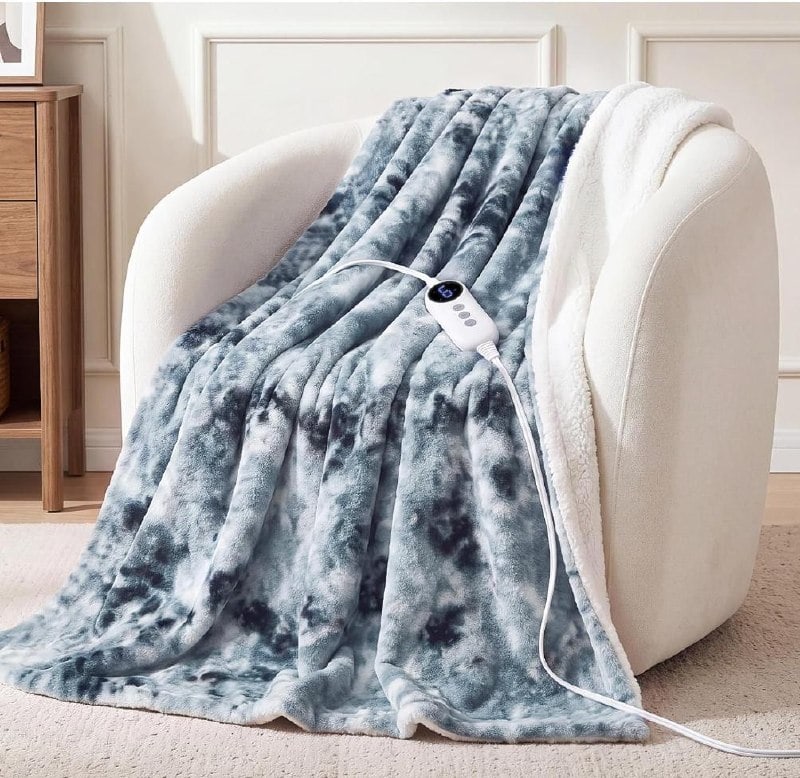 A plush weighted electric heated fur blanket draped over a bed, featured in our Wednesday Deals.
